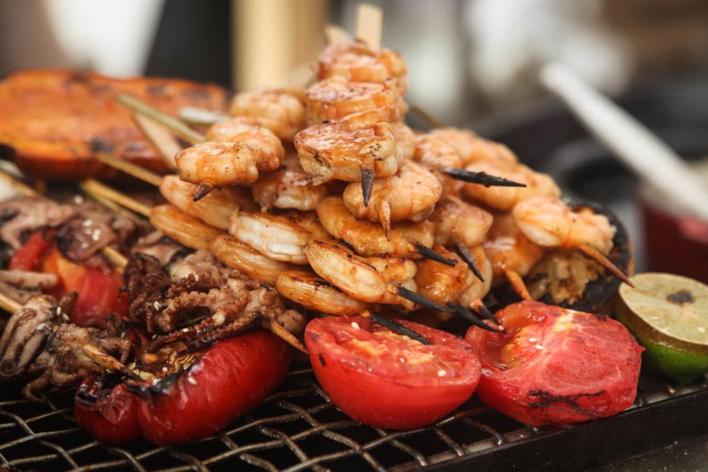 Fresh big grilled shrimp and baby octopus with tomatoes